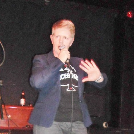 Lesley Kershaw performing, with a bottle at the back.